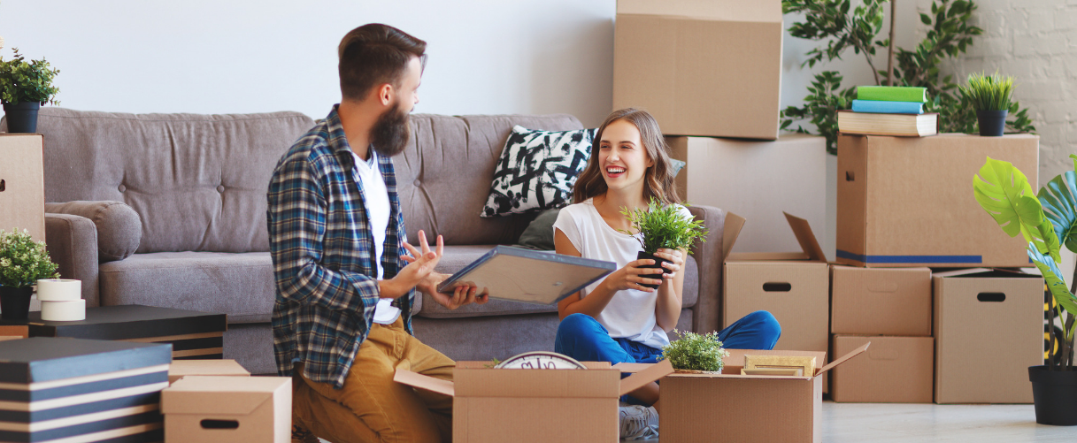 Couple with boxes in living room
