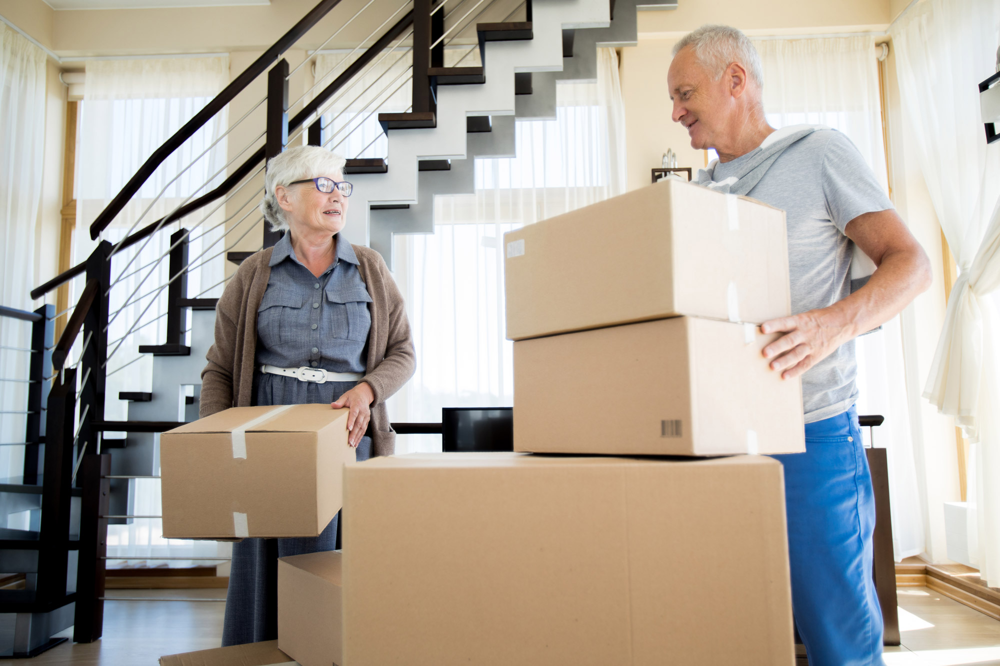 Older adults with moving boxes
